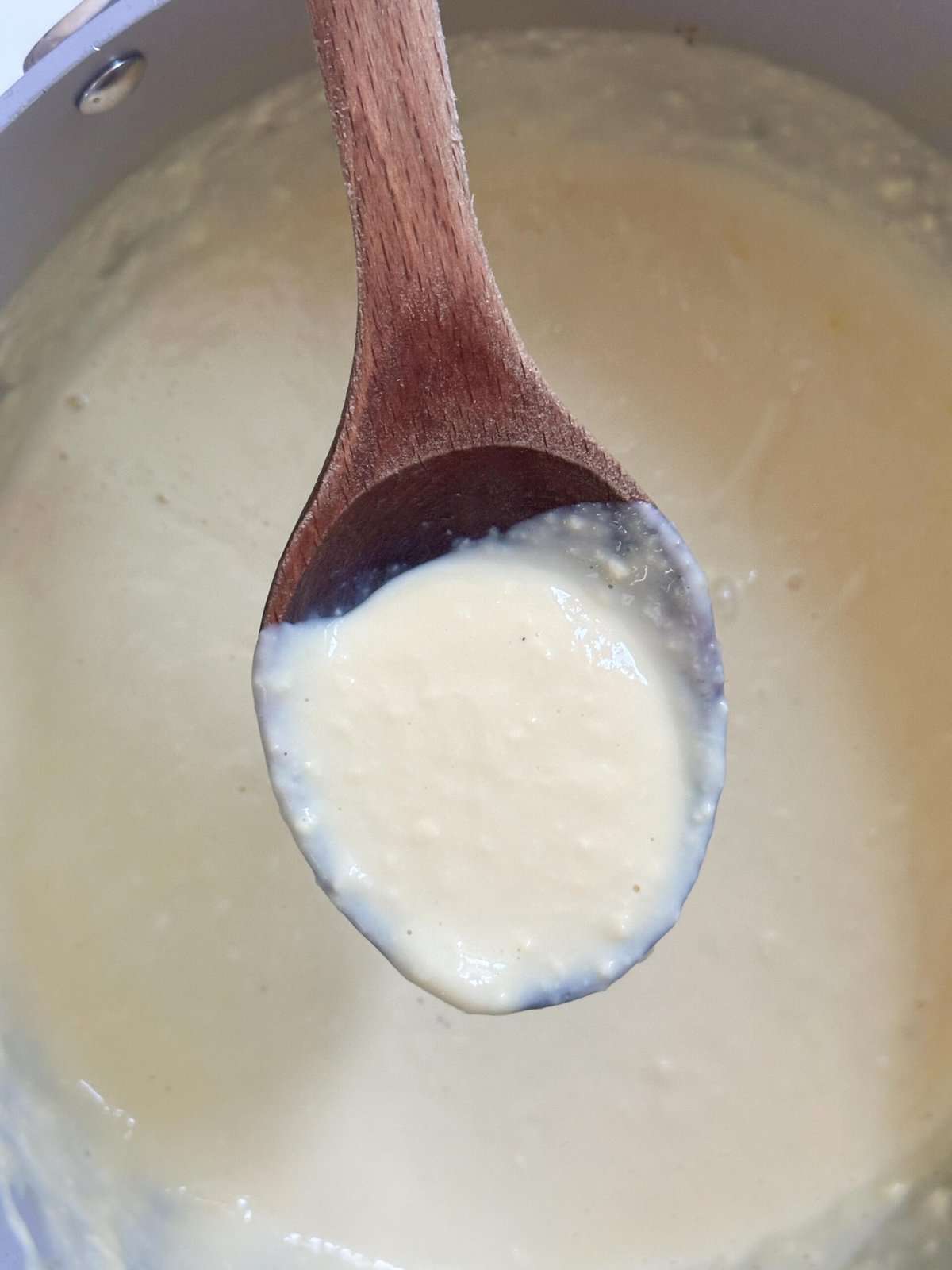 Thickened custard on a spoon.
