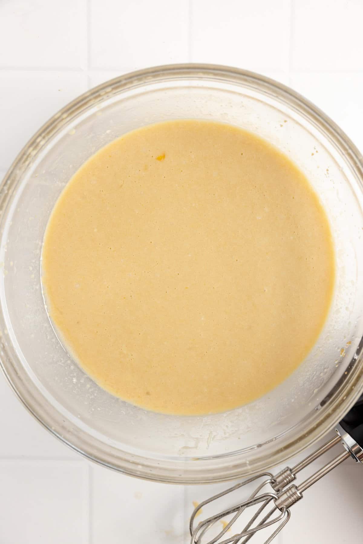 Wet ingredients mixed together in a glass bowl.