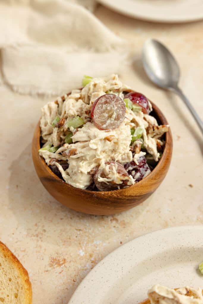 Grape chicken salad in a wooden bowl.