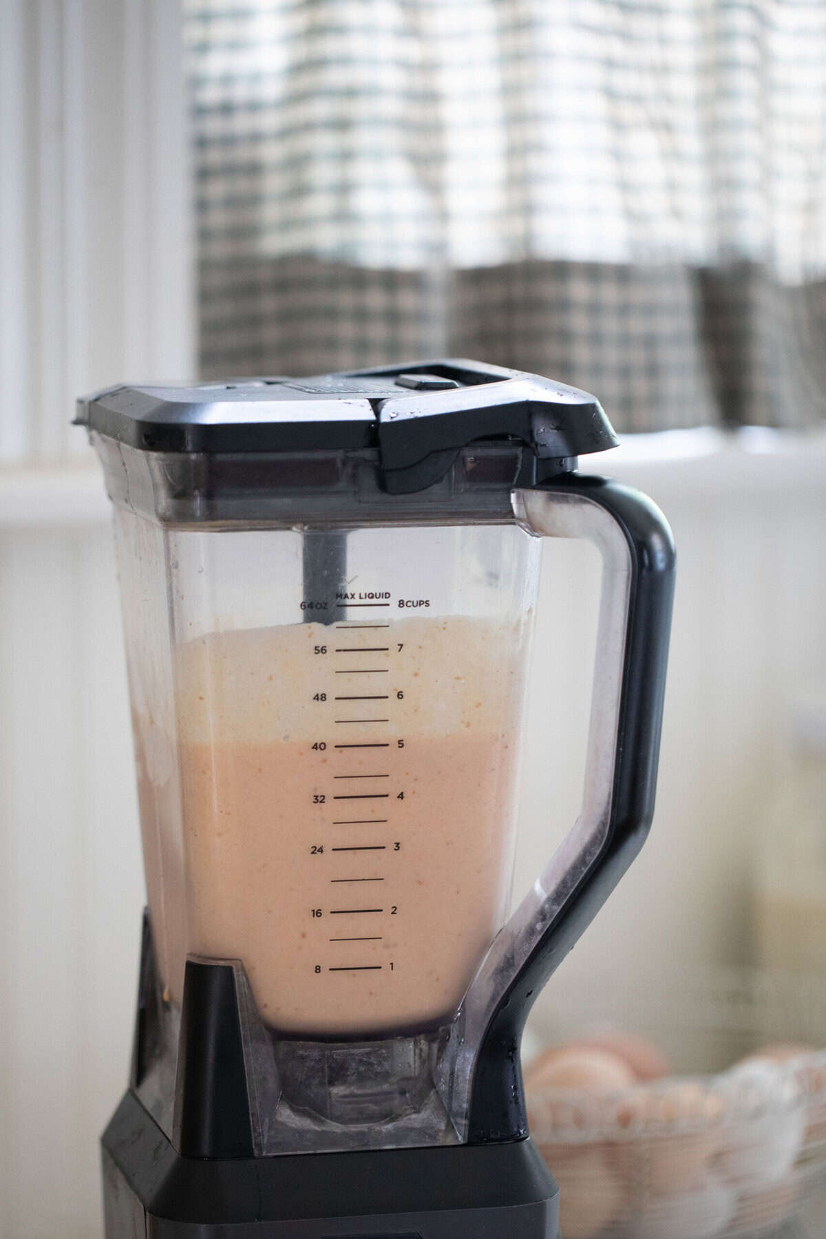 Pumpkin smoothie blended up in a blender.