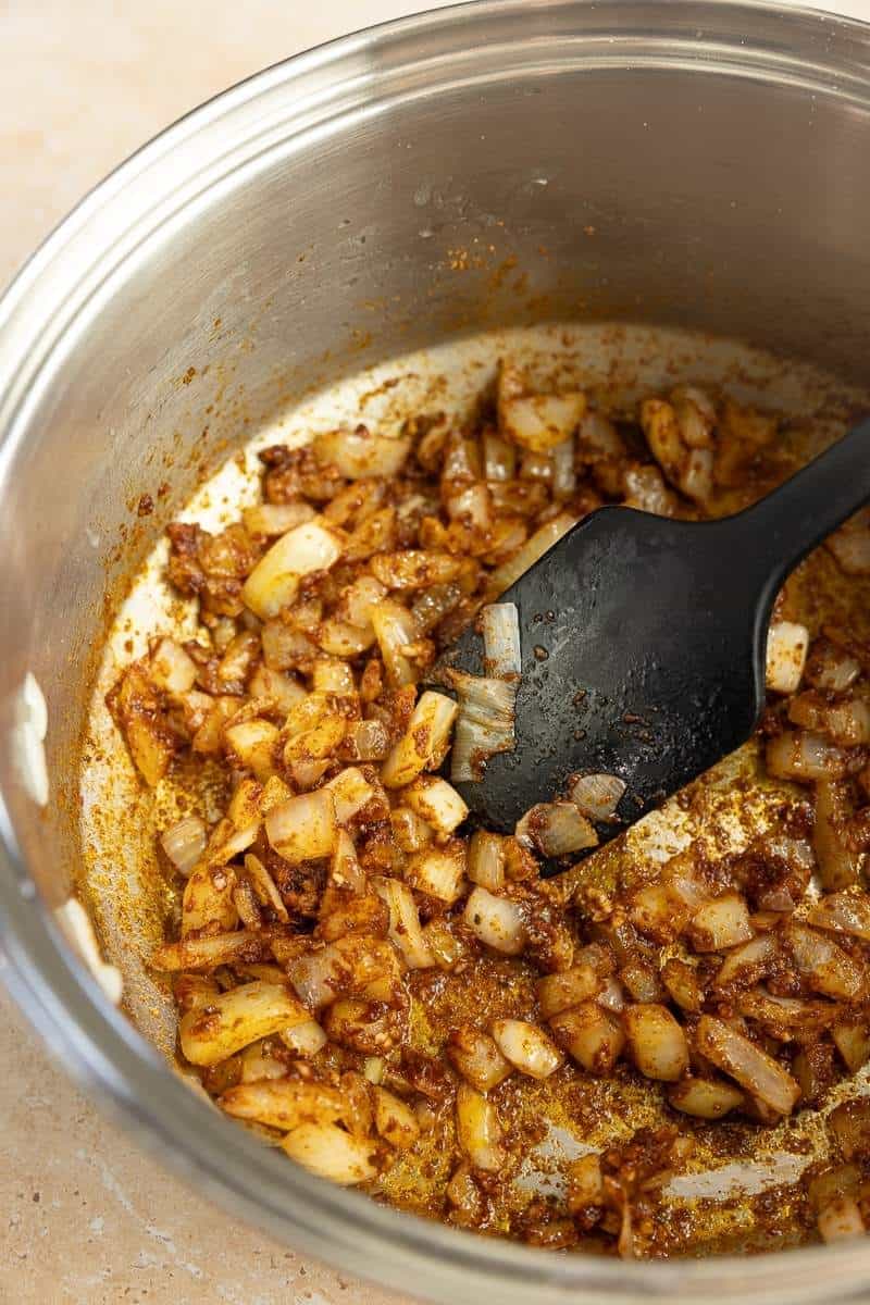 Sauted onions mixed with taco seasoning in a large stock pot.