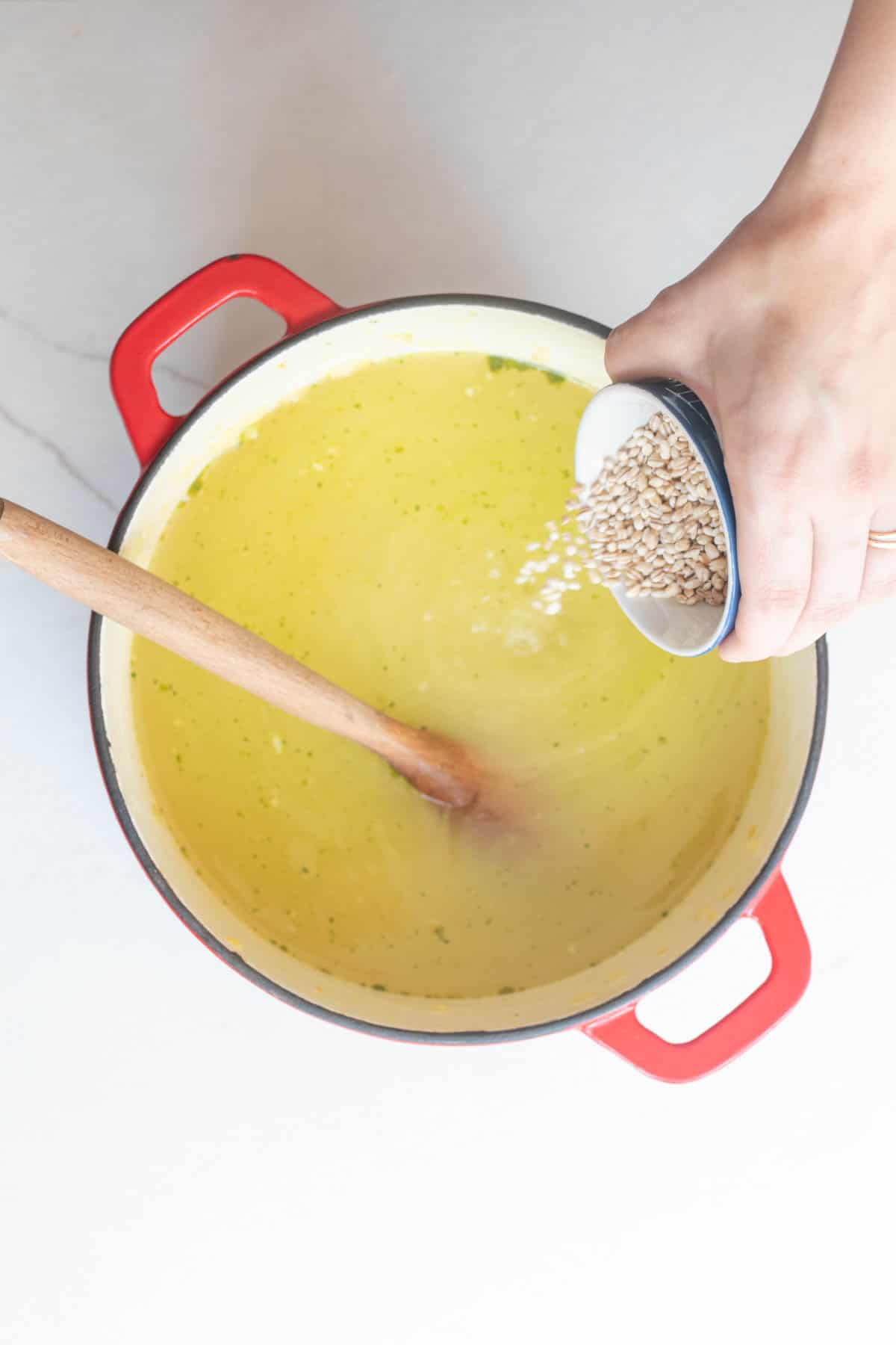 Barley added to a pot of soup.