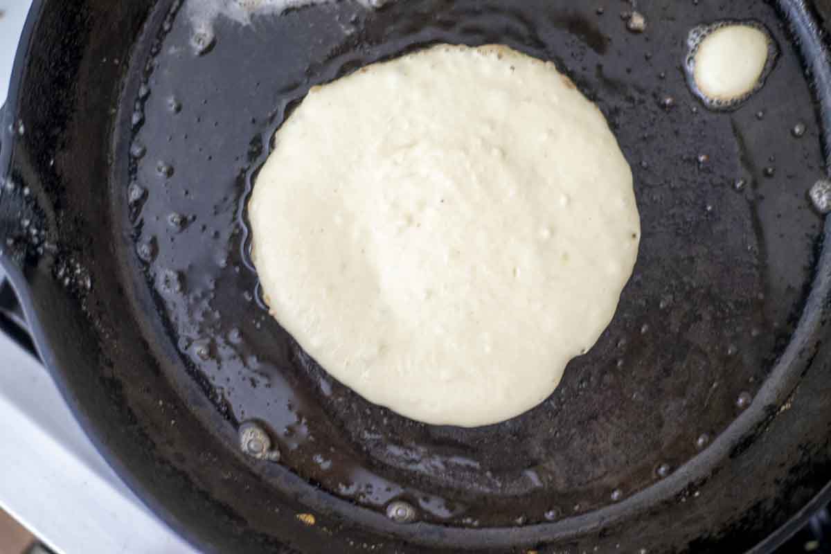 A pancake on a hot griddle. 