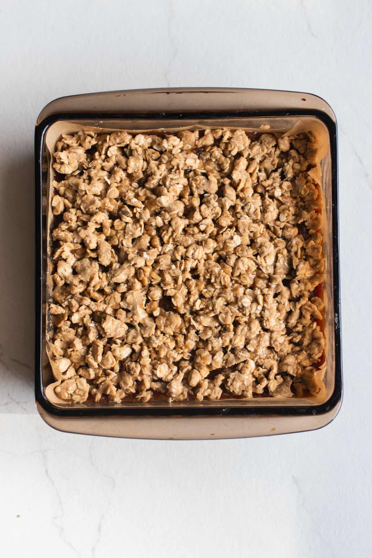 The topping added to the date squares in a square baking pan.