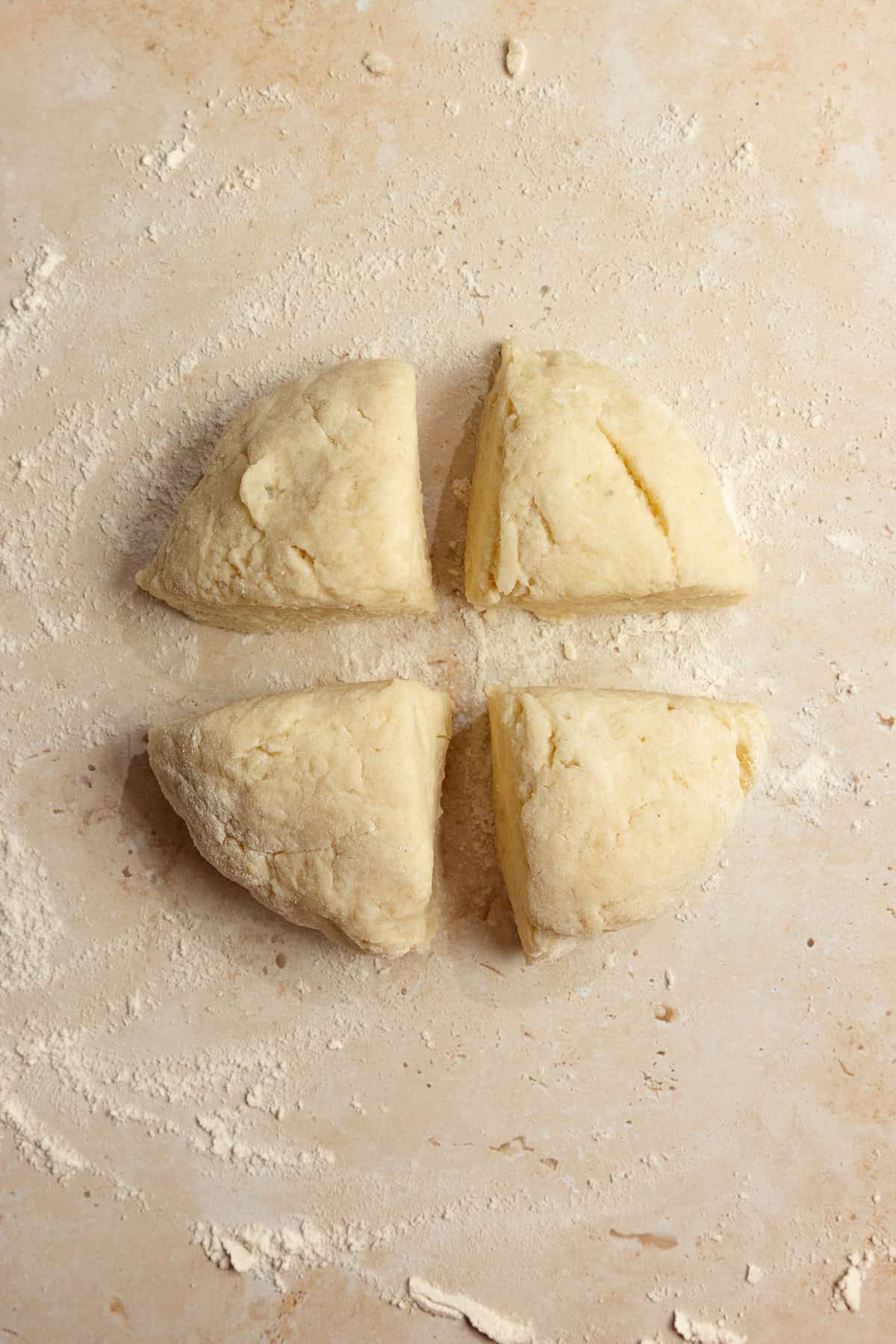 A dough ball cut into four sections.