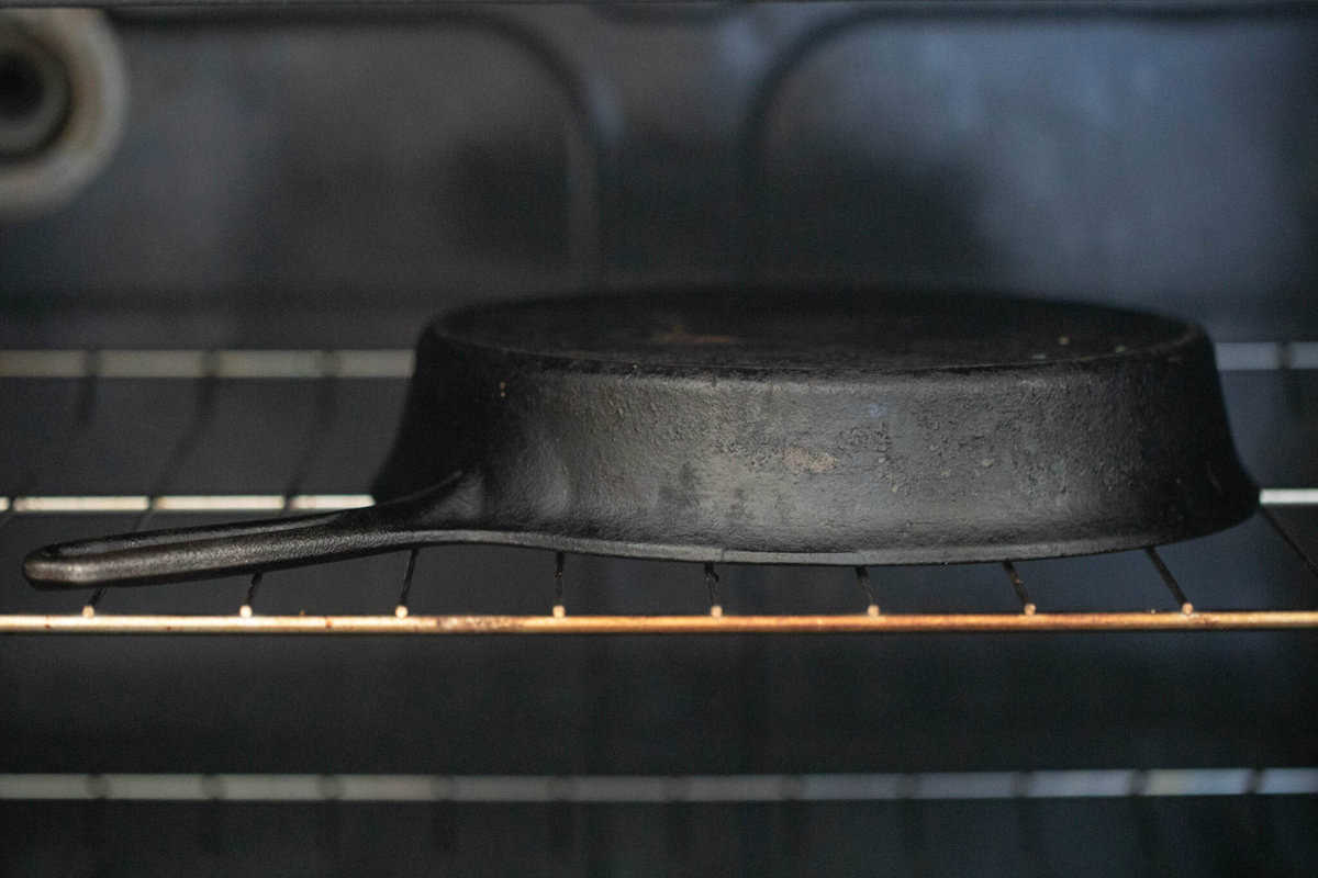 Cast iron skillet upside down in an oven.