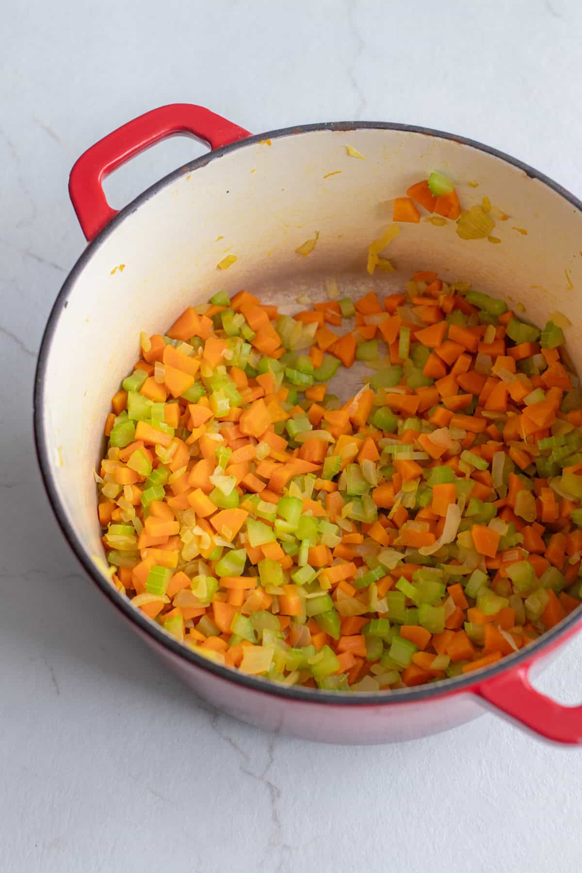 Carrots and celery in a Dutch oven.