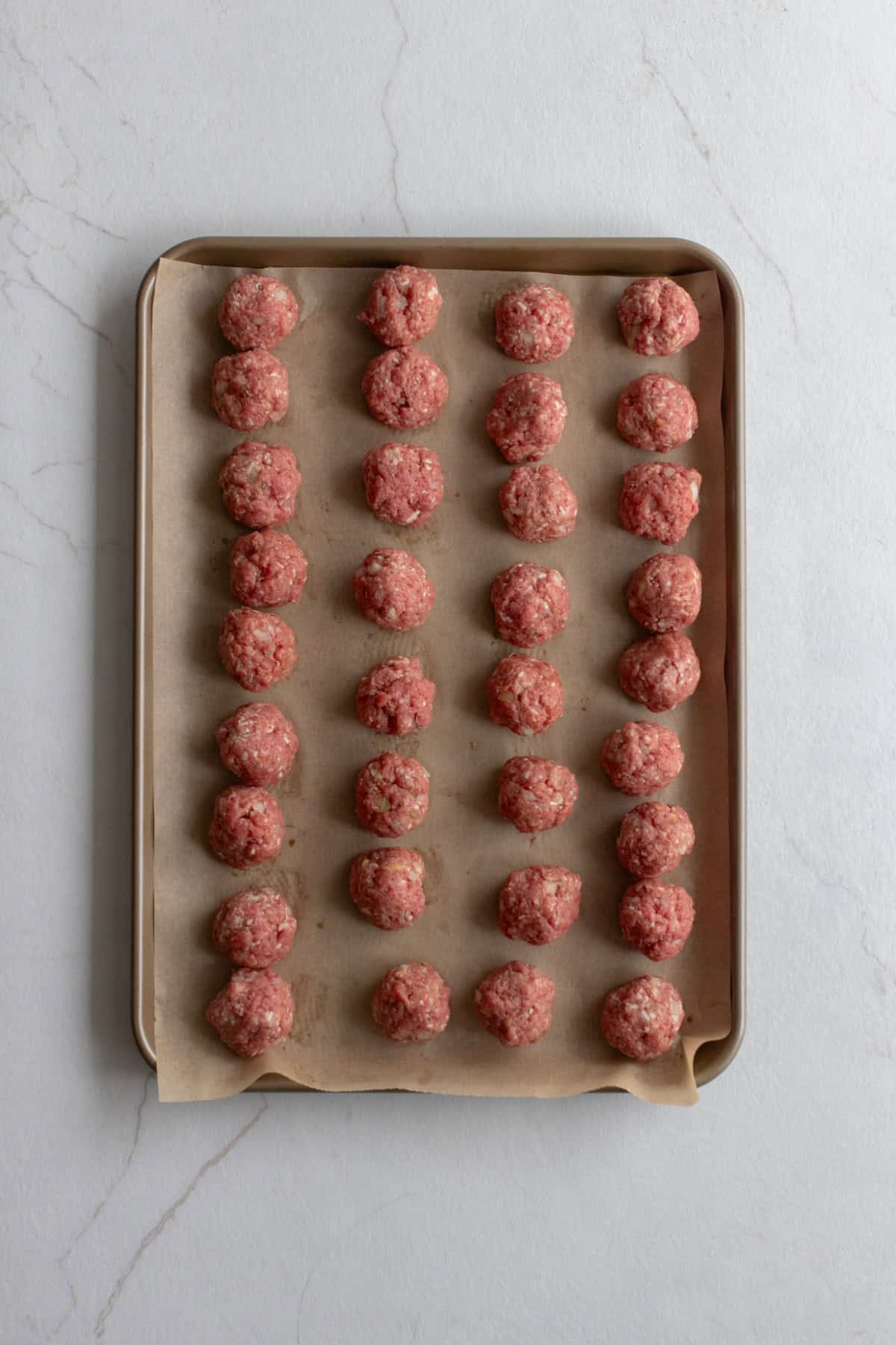 Meatballs on a baking sheet.