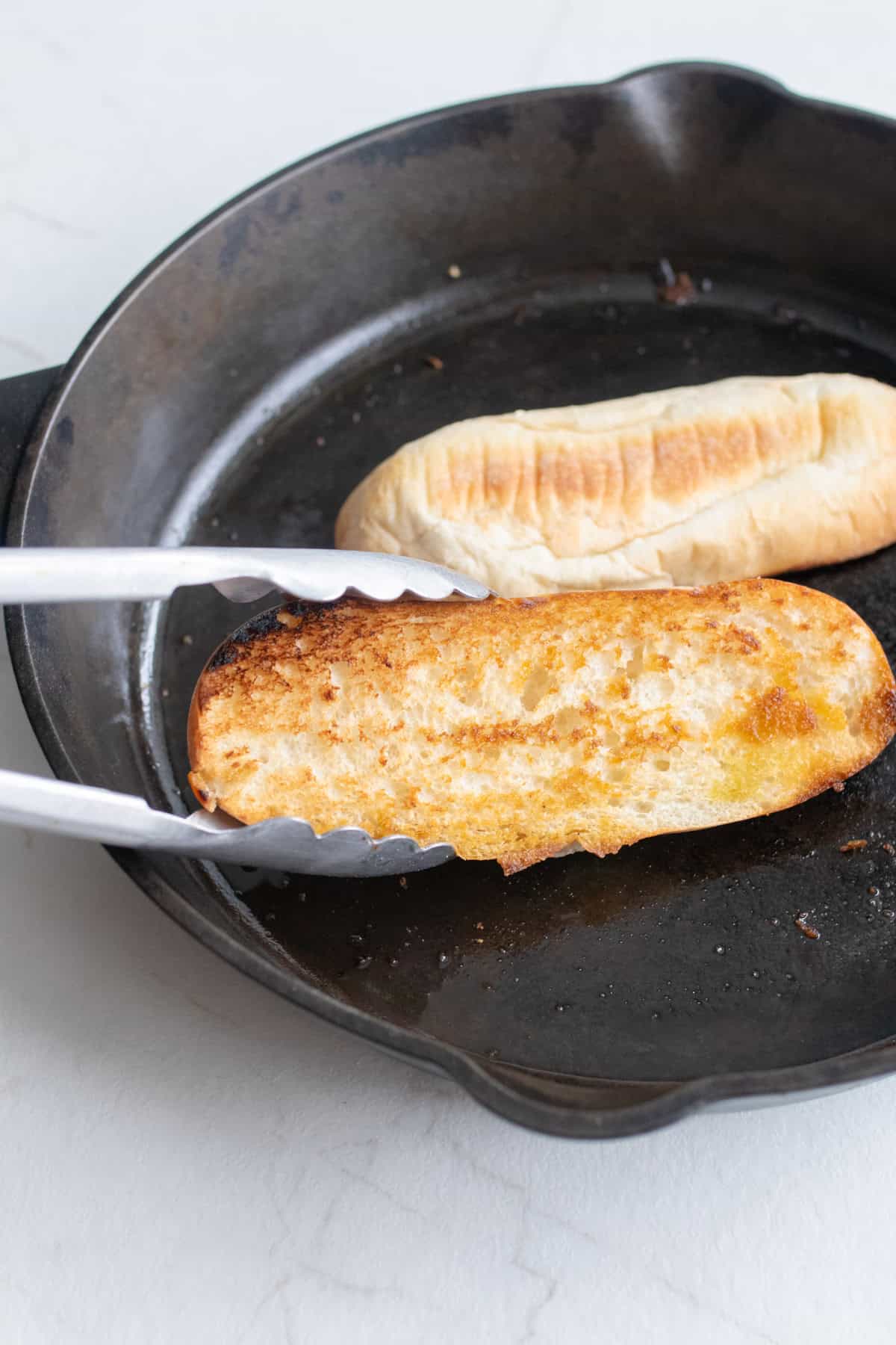 Buns toasted in a cast iron skillet.