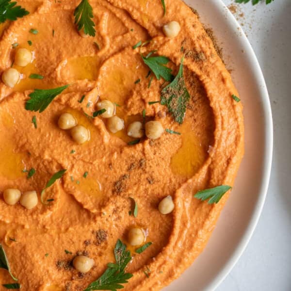 A bowl of roasted red pepper hummus.