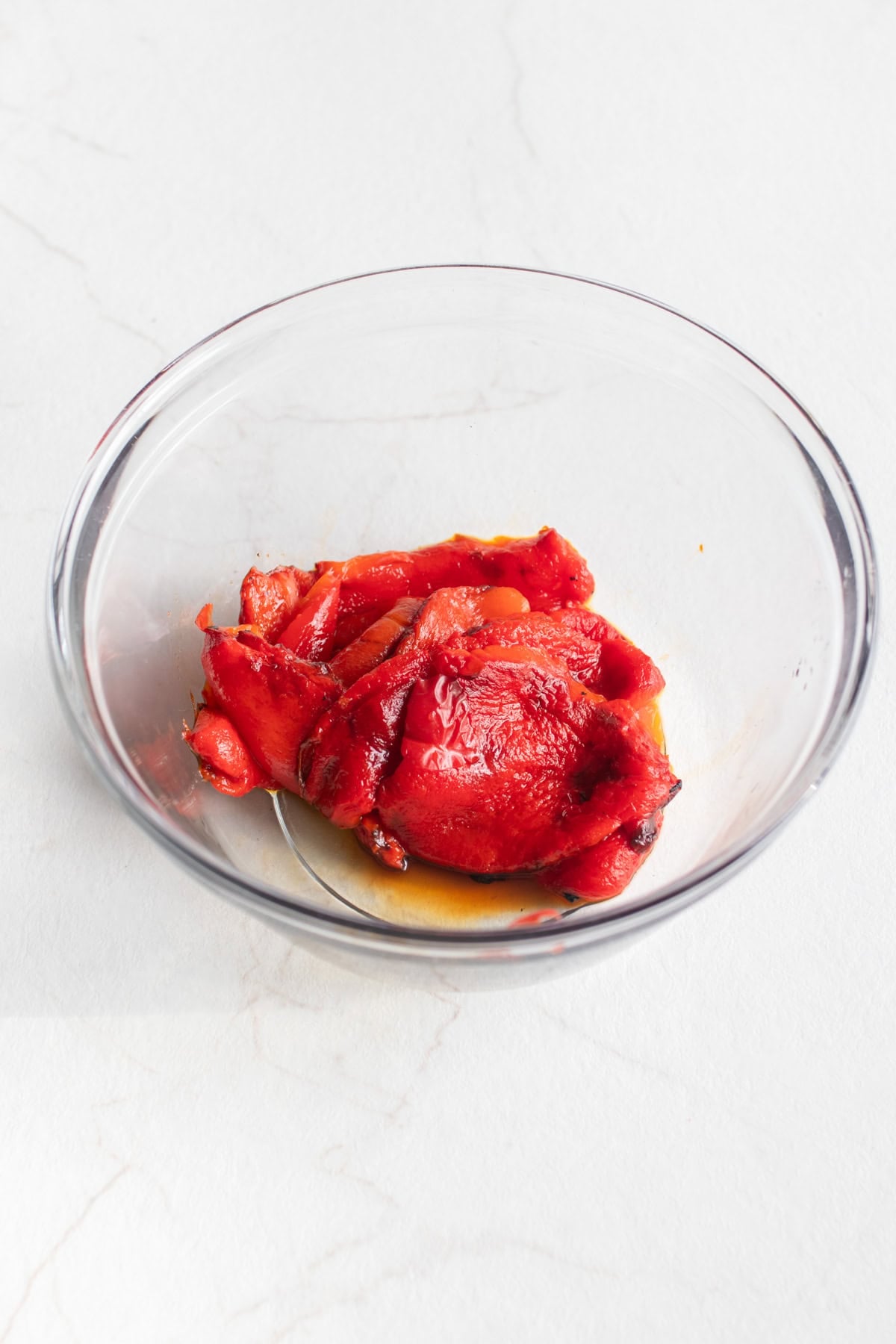 Roasted bell peppers in a bowl with skin removed.