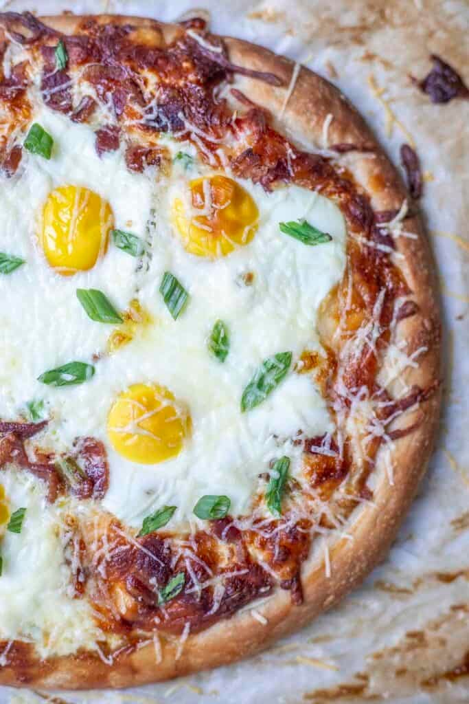 Half of a baked breakfast pizza.