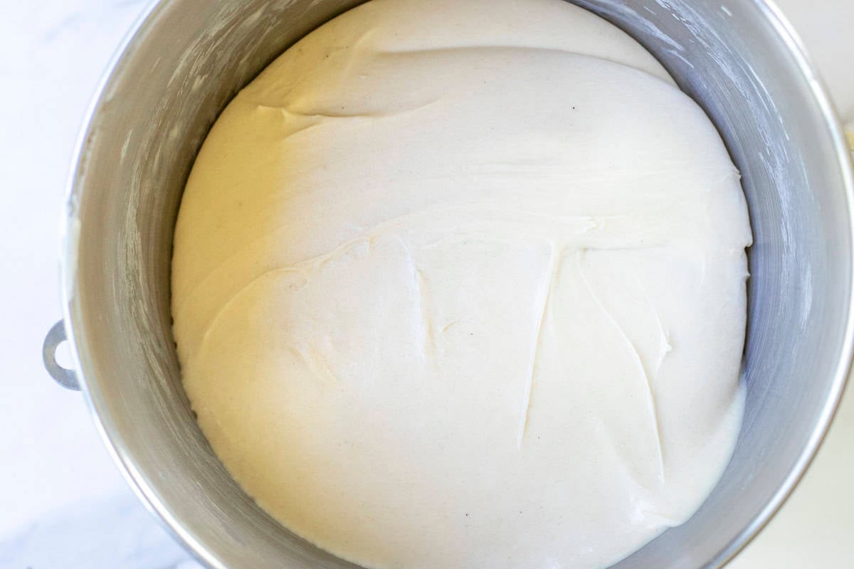 Pizza dough in a stand mixer bowl.