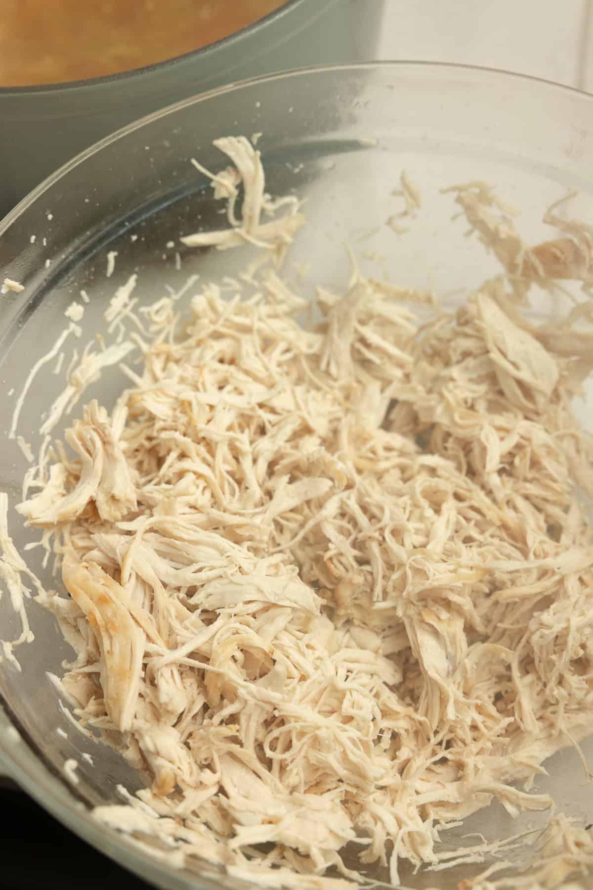 Chicken shredded in a bowl.