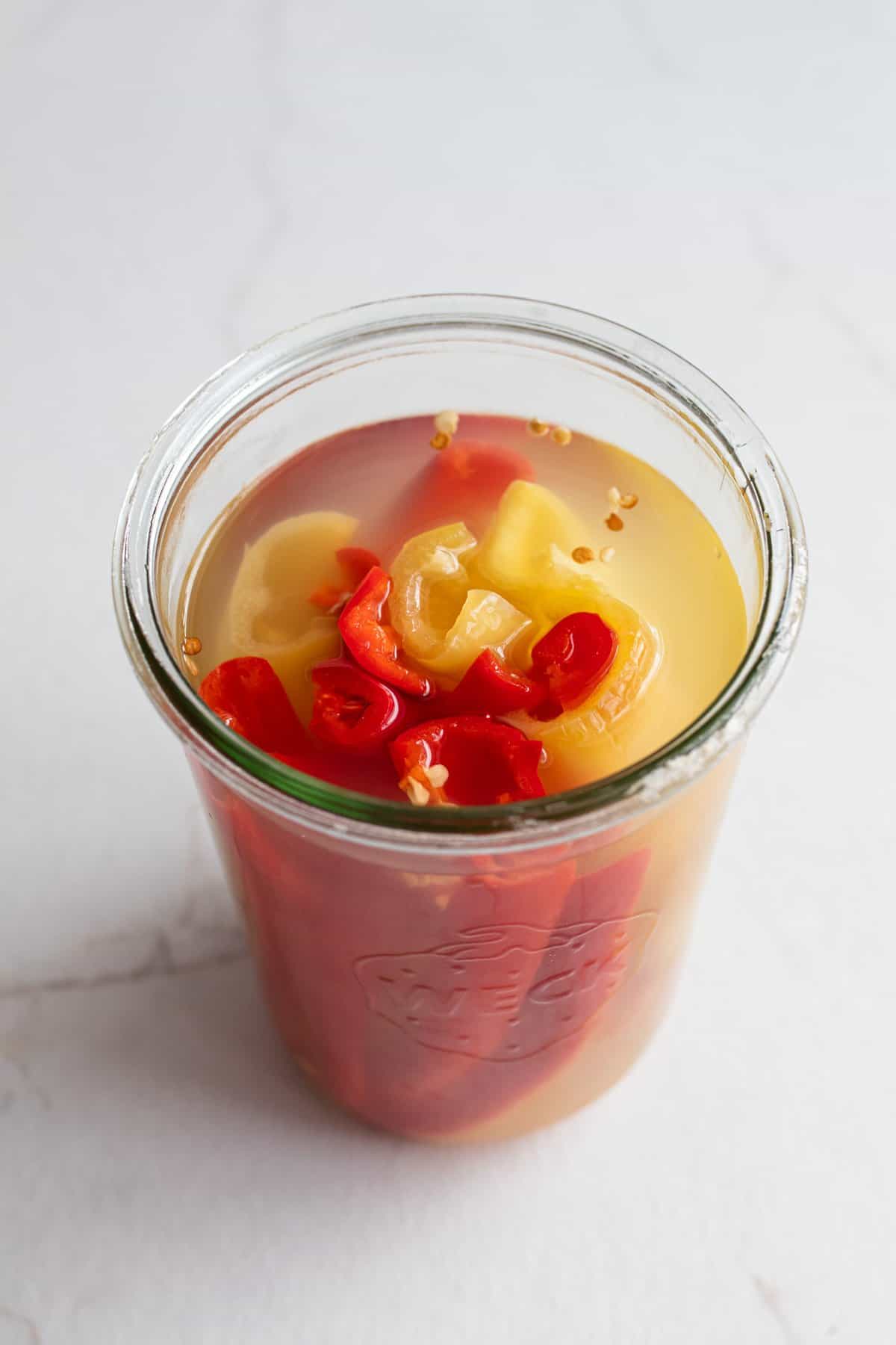 Fermented peppers after fermentation in a glass jar.