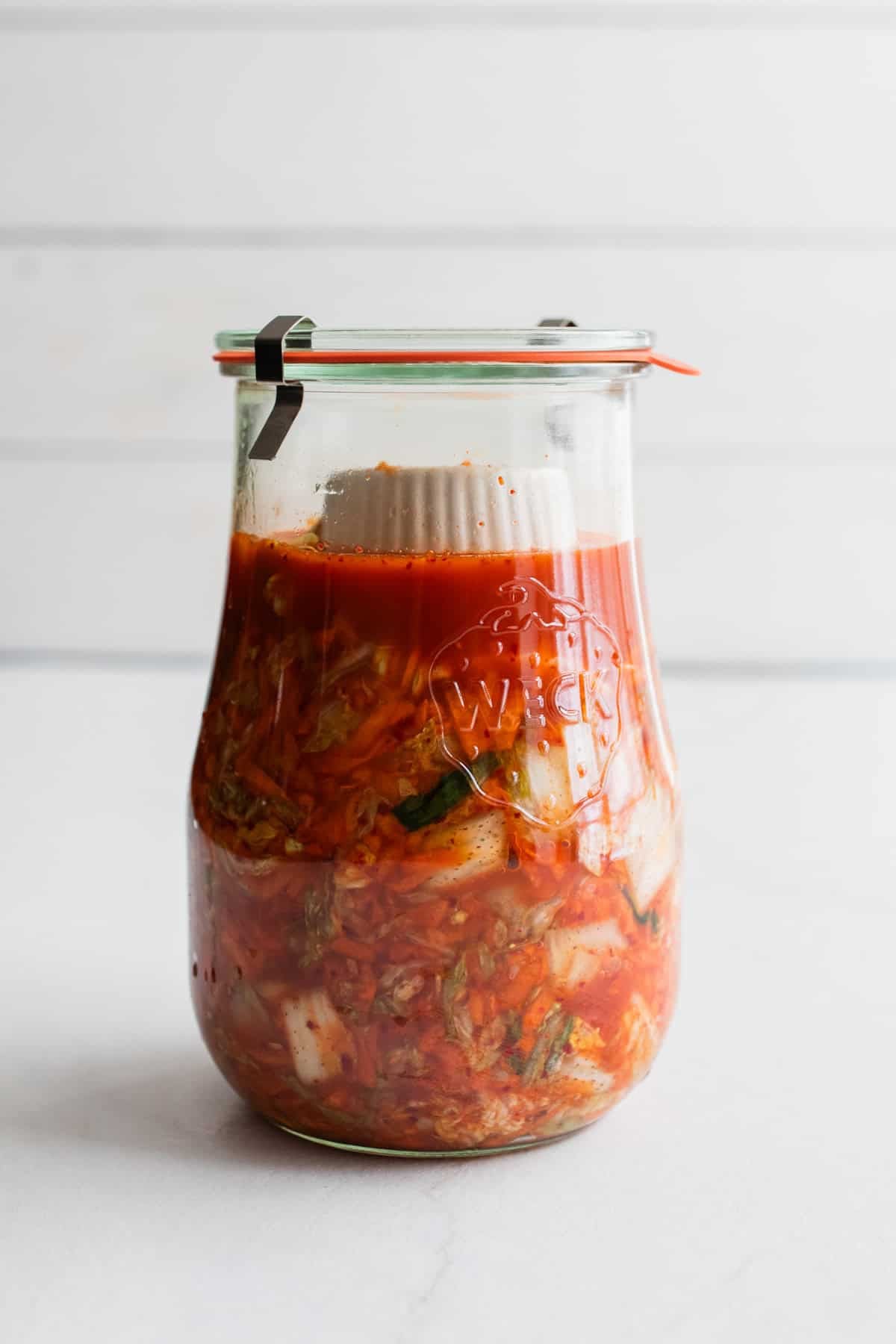 A jar of kimchi with the lid on.