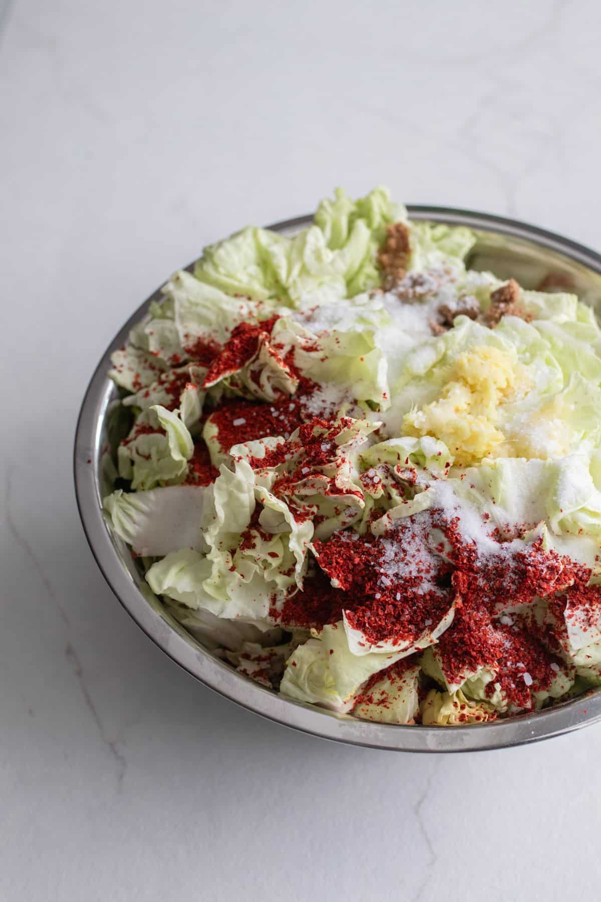 Cabbage and other ingredients in a large bowl.