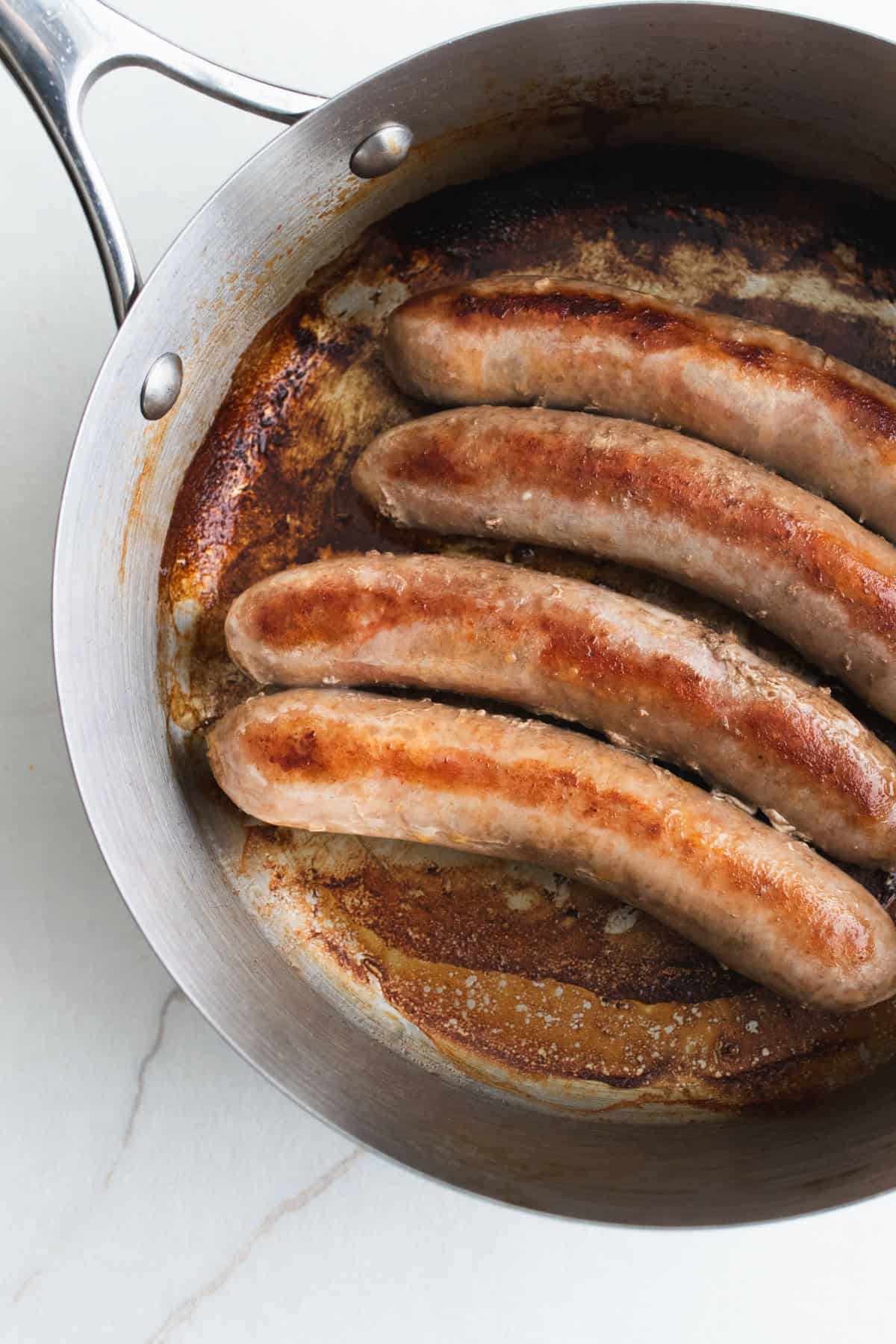 Sausages in a skillet.