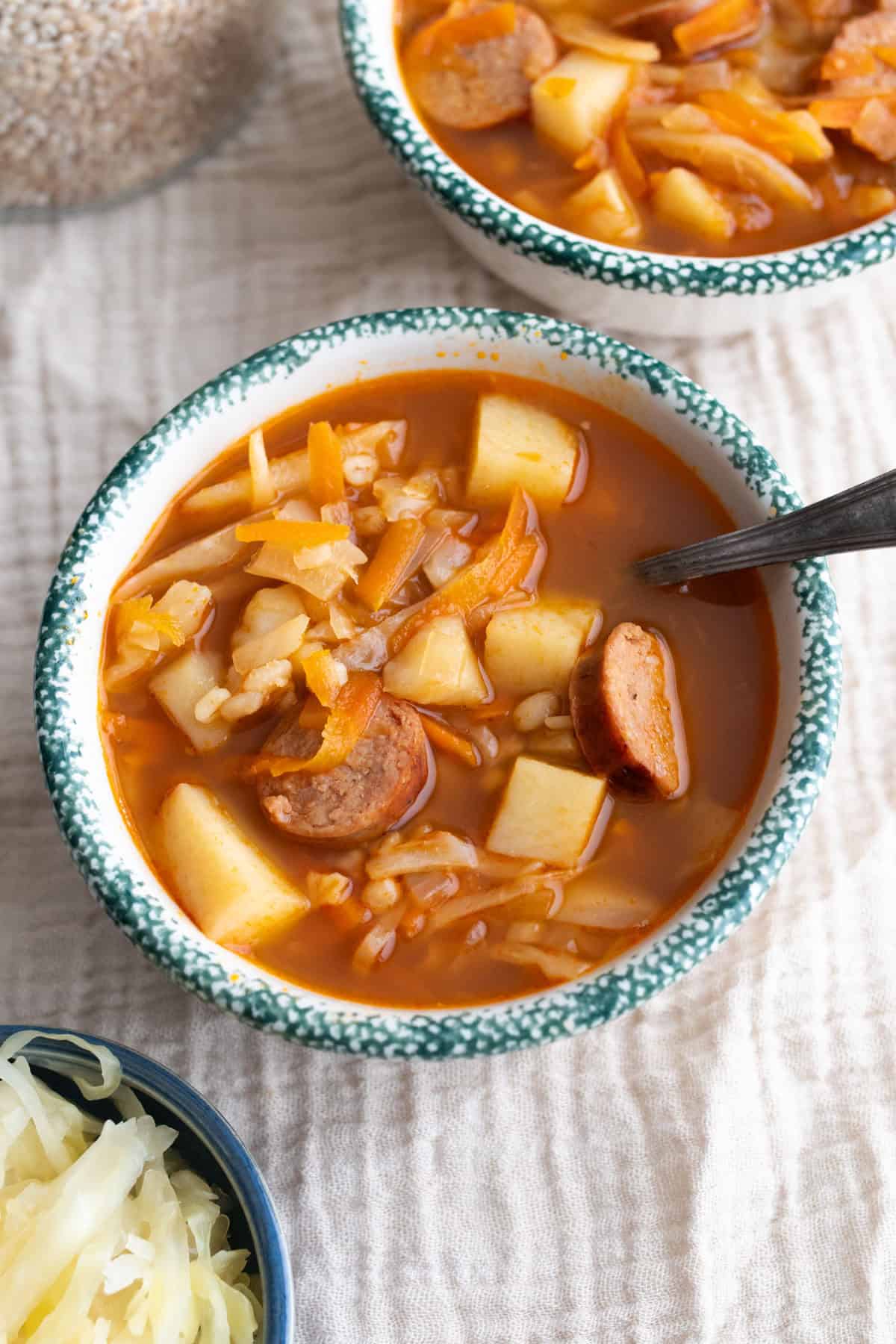 A bowl of soup with a spoon in it.
