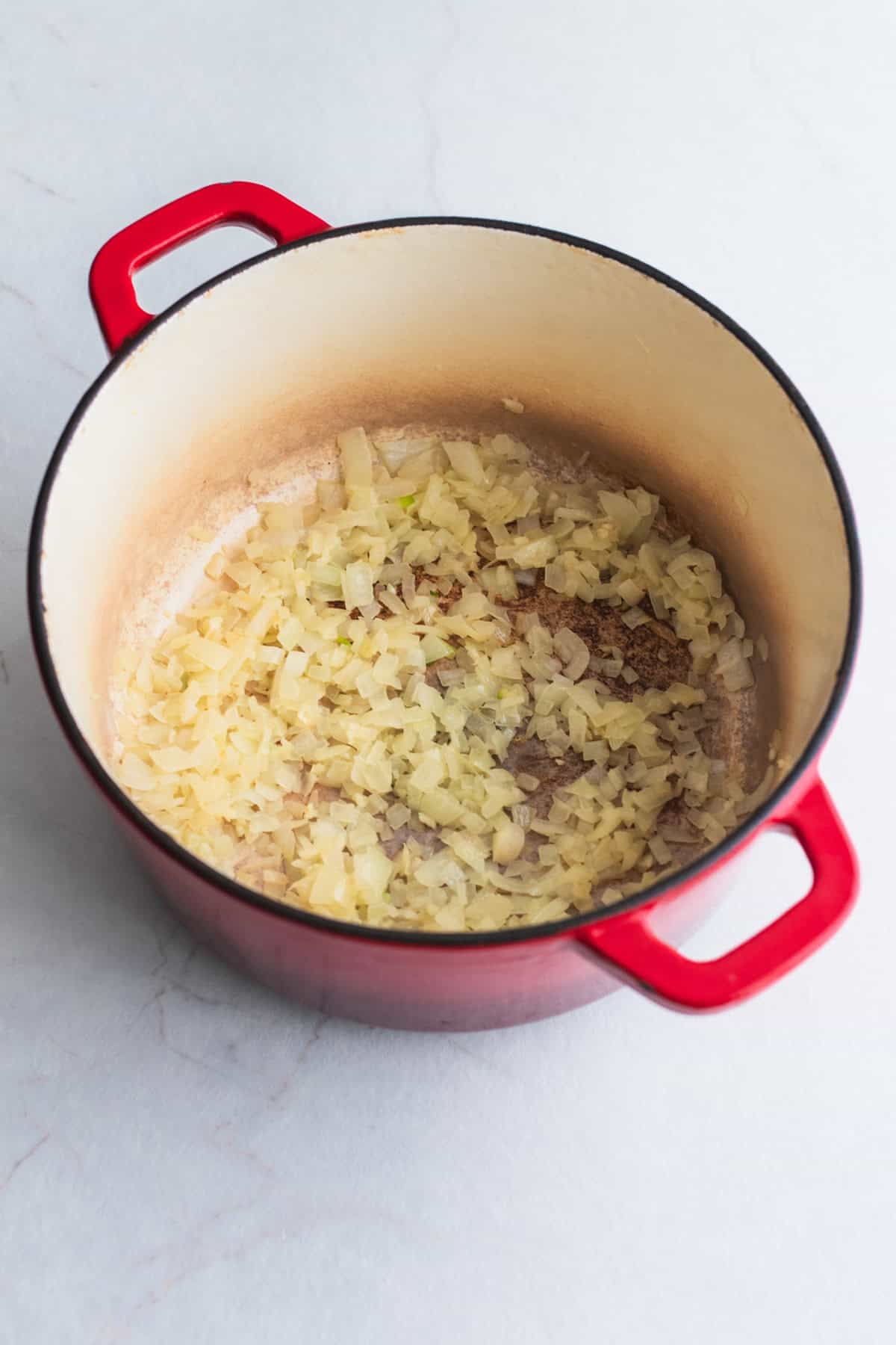 Onions cooking in a Dutch oven.