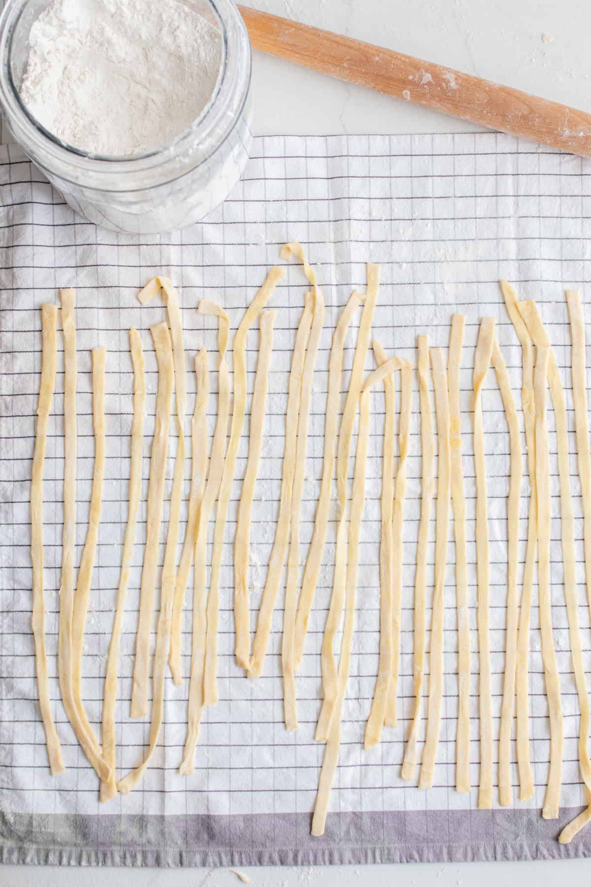 Sourdough pasta drying on a towel.