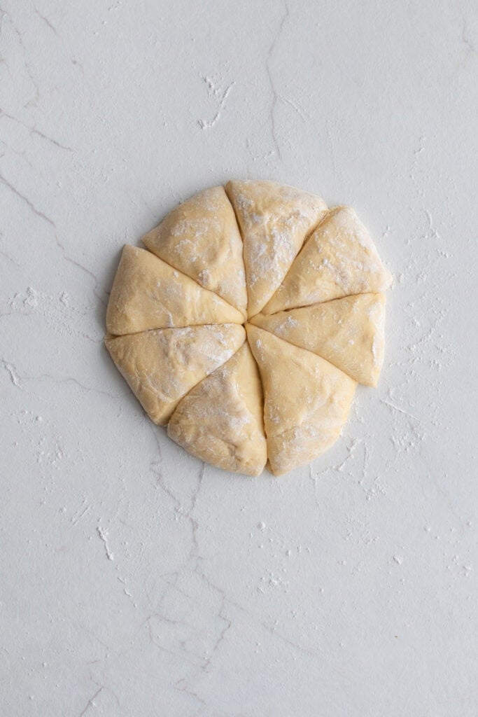 A dough ball divided into eight pieces. 