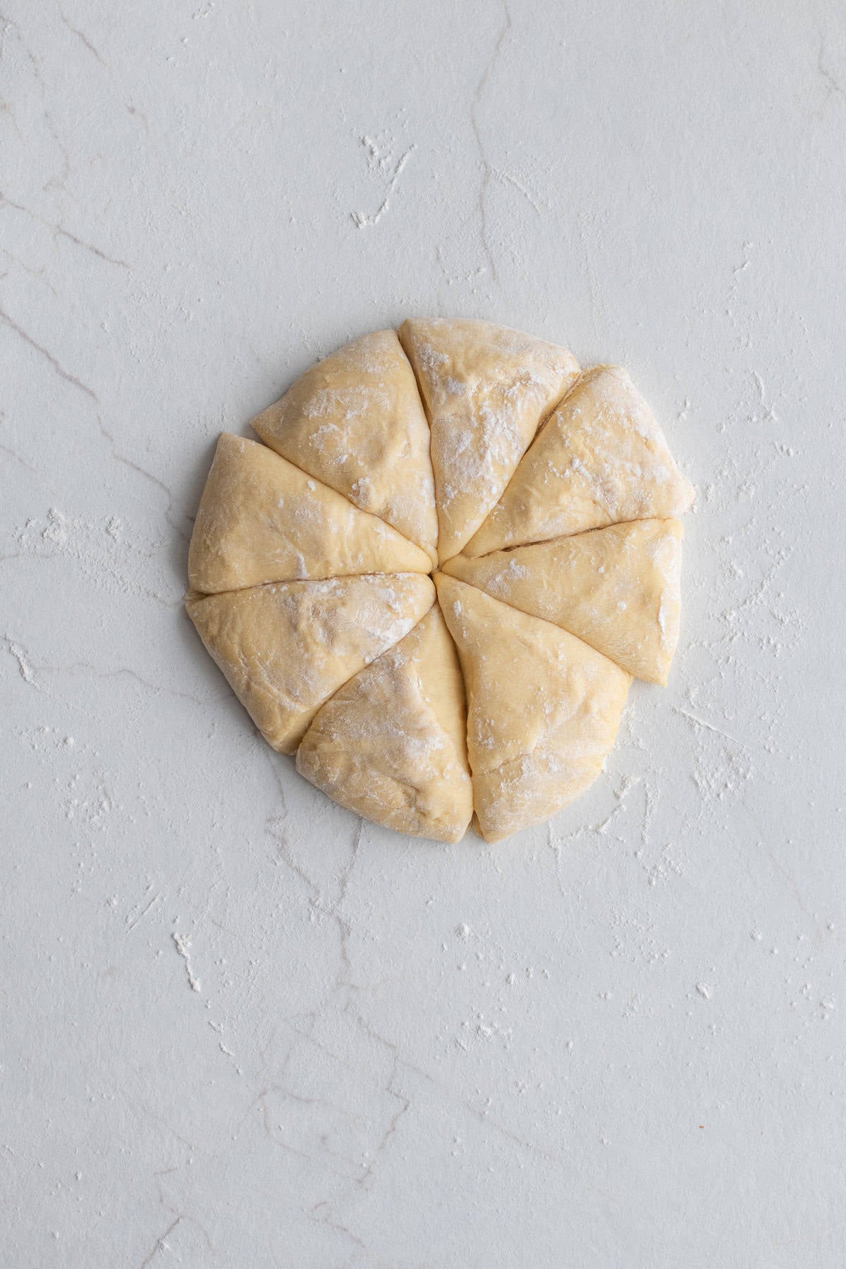 A dough ball divided into eight pieces.