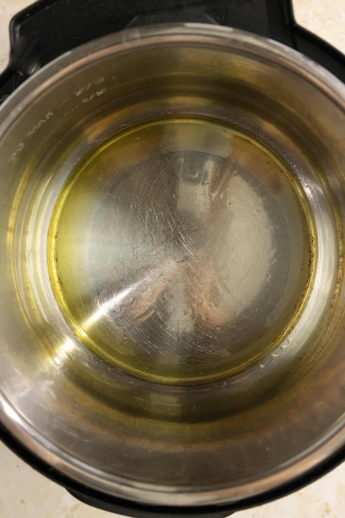 Oil in the bottom of an instant pot.