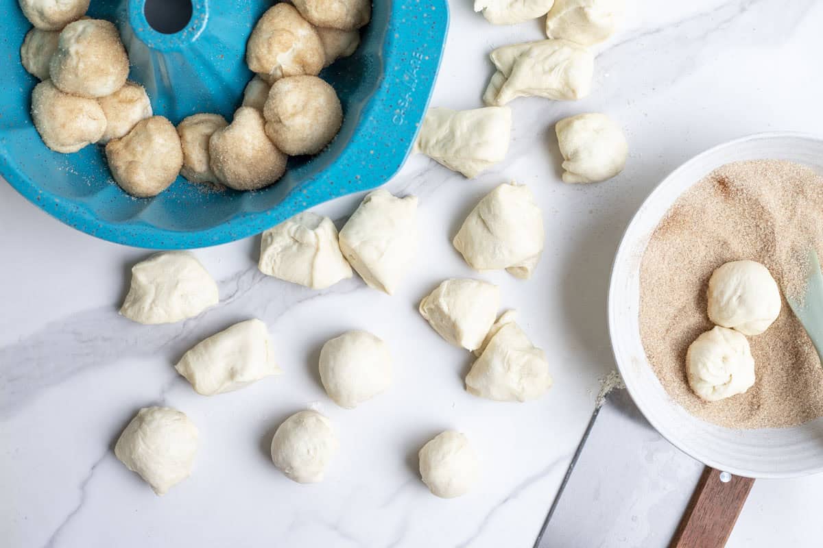 shaping dough balls and rolling in sugar.