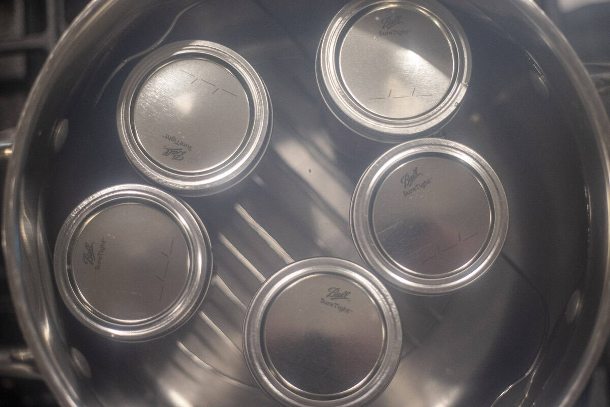 Jars with lids in a pot of boiling water.