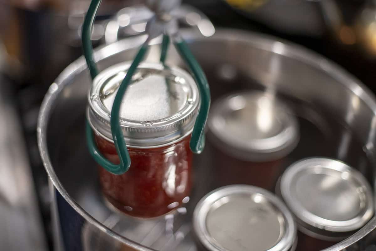 A jar removed from a pot of boiling water.