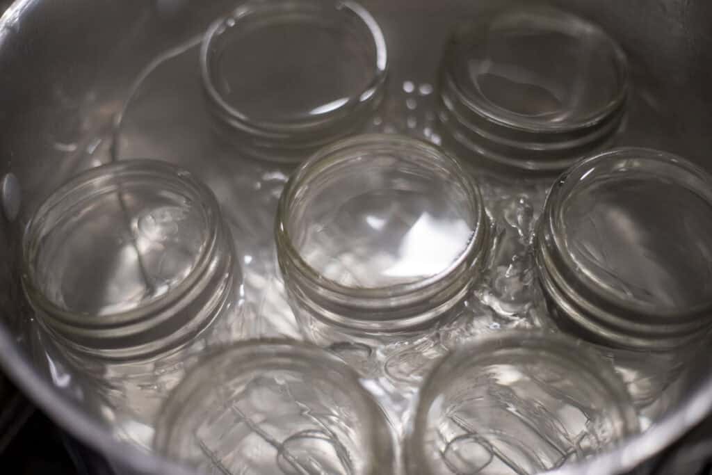 Jars in a pot of water.