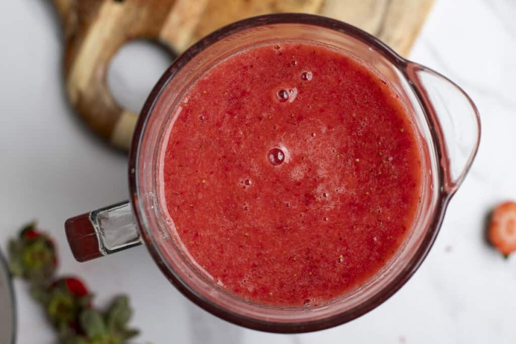 Strawberries blended in a blender.