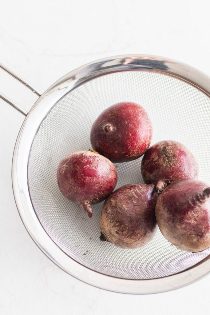 Beets in a strainer.