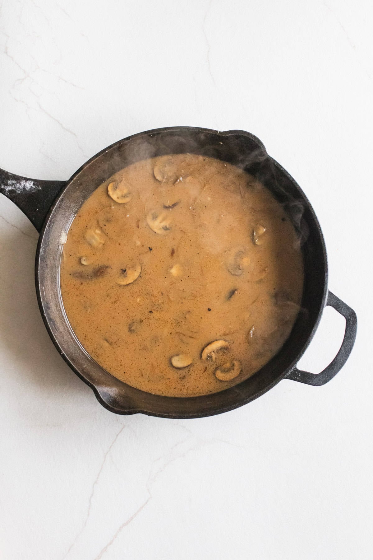 onion and mushroom gravy in a cast iron skillet.