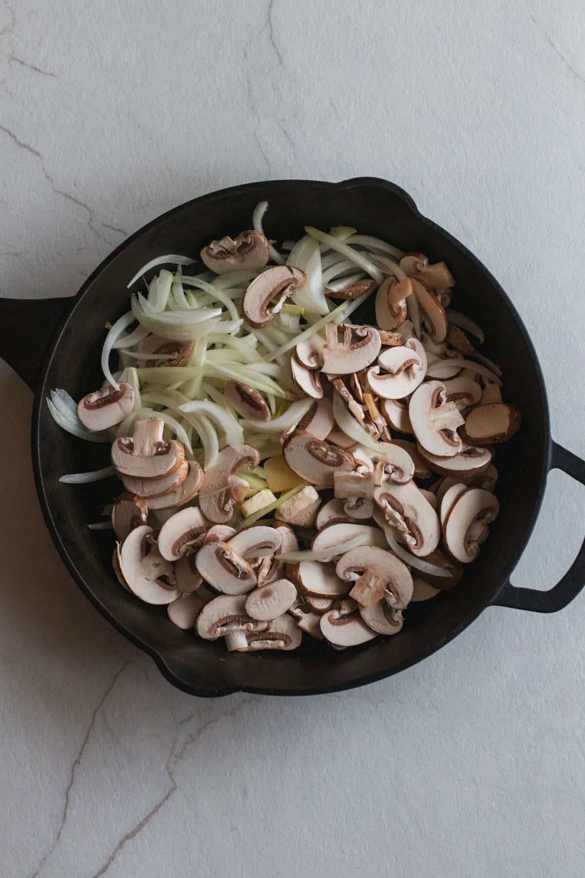 onions and mushrooms in a cast iron skillet.