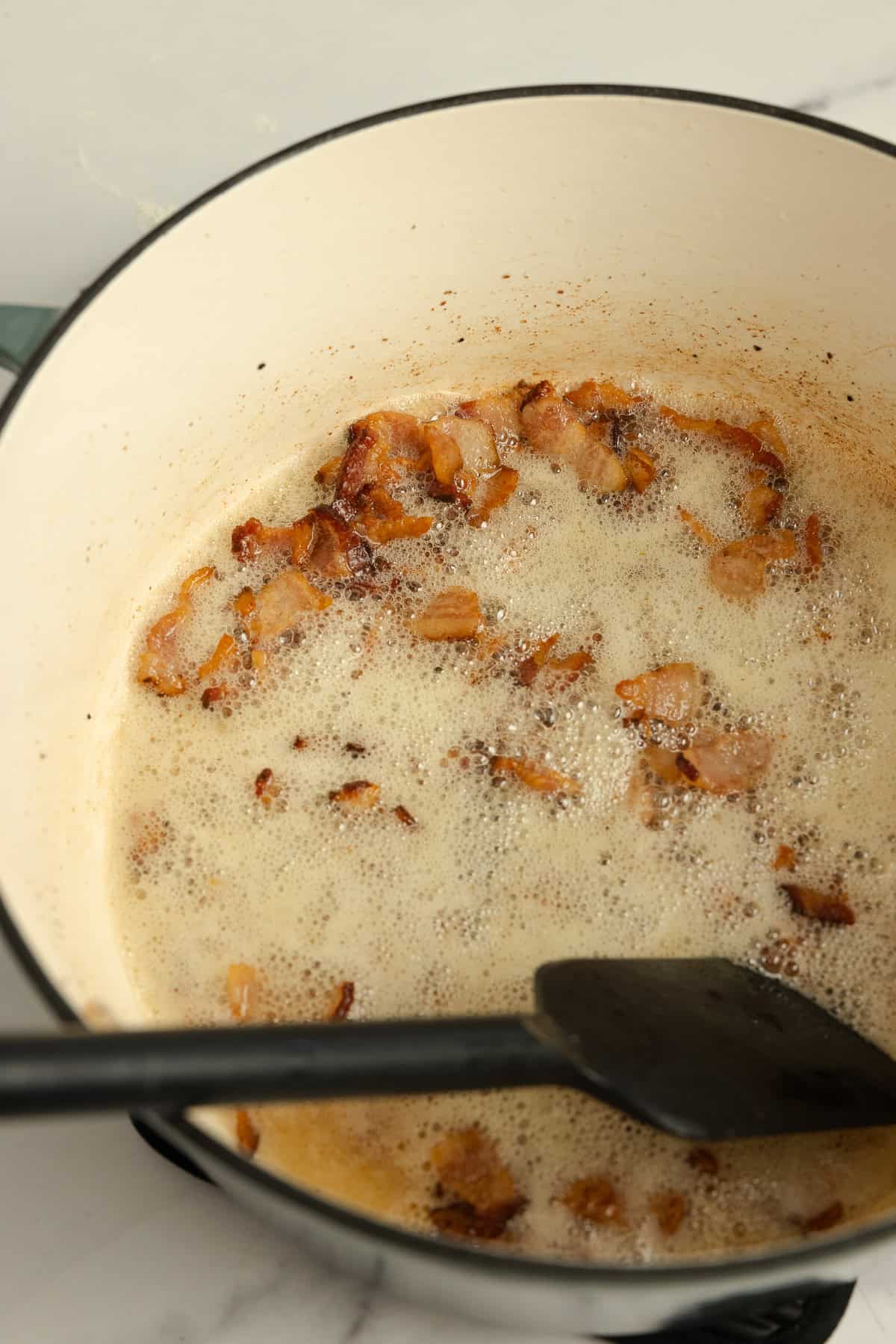 Cooking bacon in a pot.