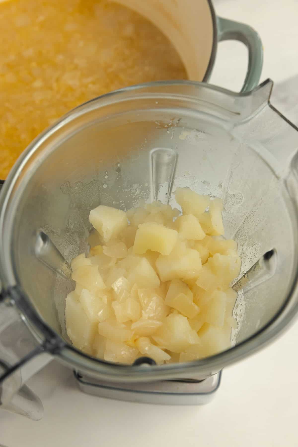 Blending cooked potatoes in a blender.