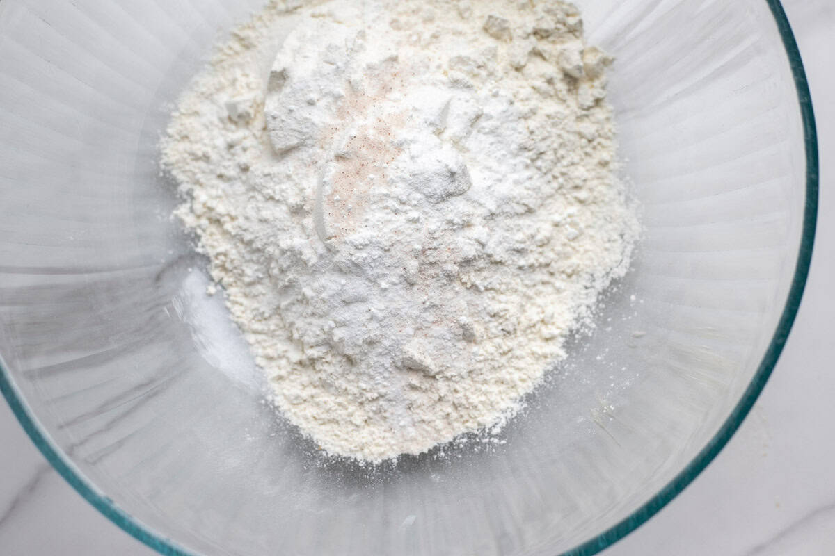 Sugar, flour, salt, baking powder and baking soda in a bowl.