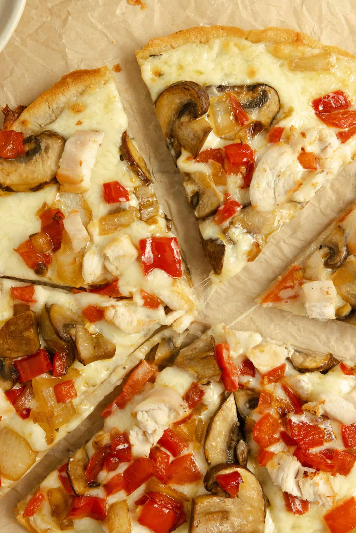 A sliced pizza chicken alfredo pizza.