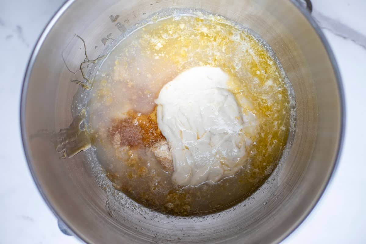 Whole wheat flour, water, melted butter, honey, sourdough starter, and salt in a stand mixer bowl.