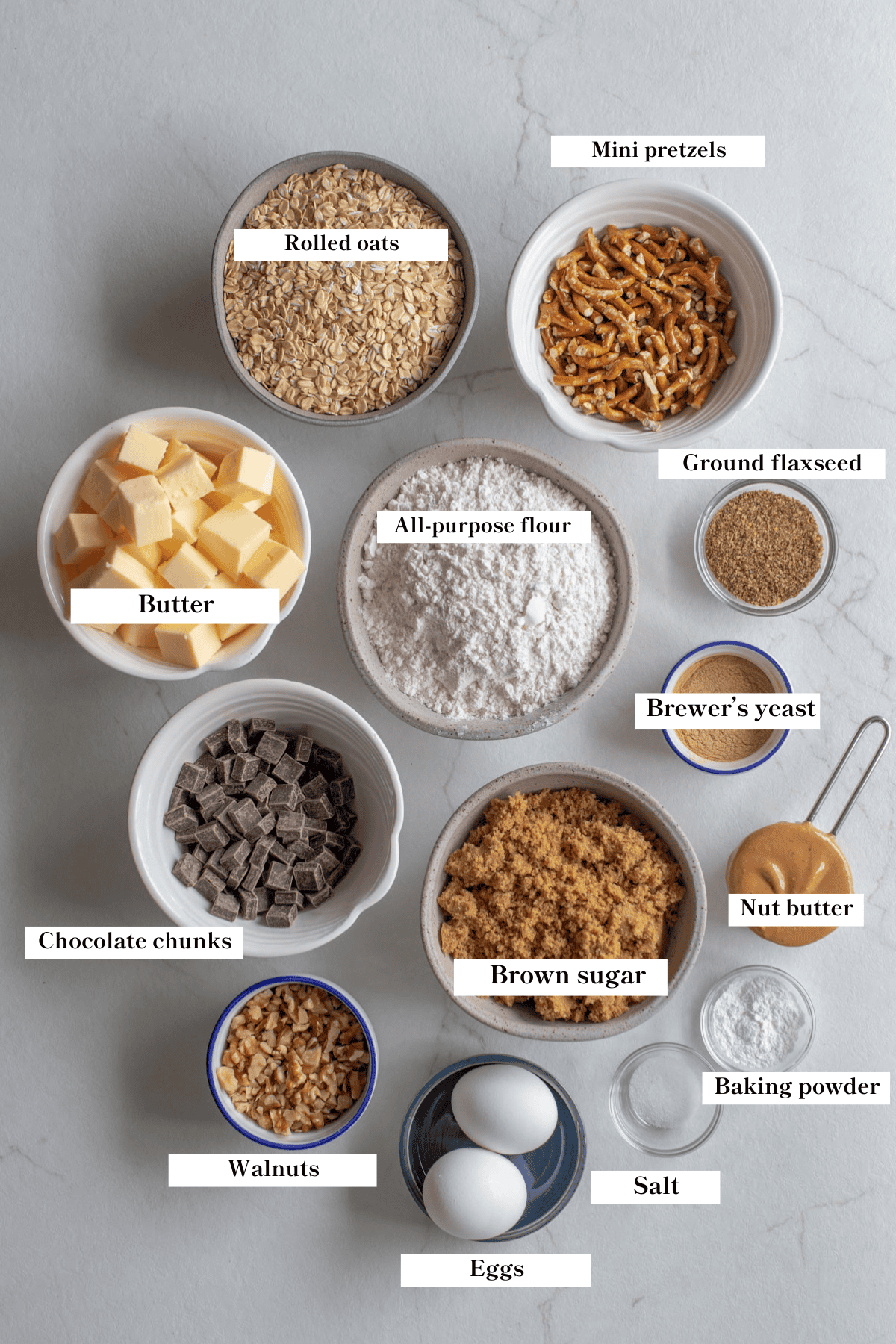 Ingredients for lactation cookies in bowls on a countertop. 