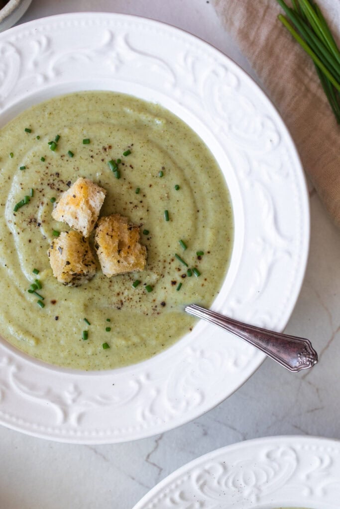 a bowl of soup with croutons on top.