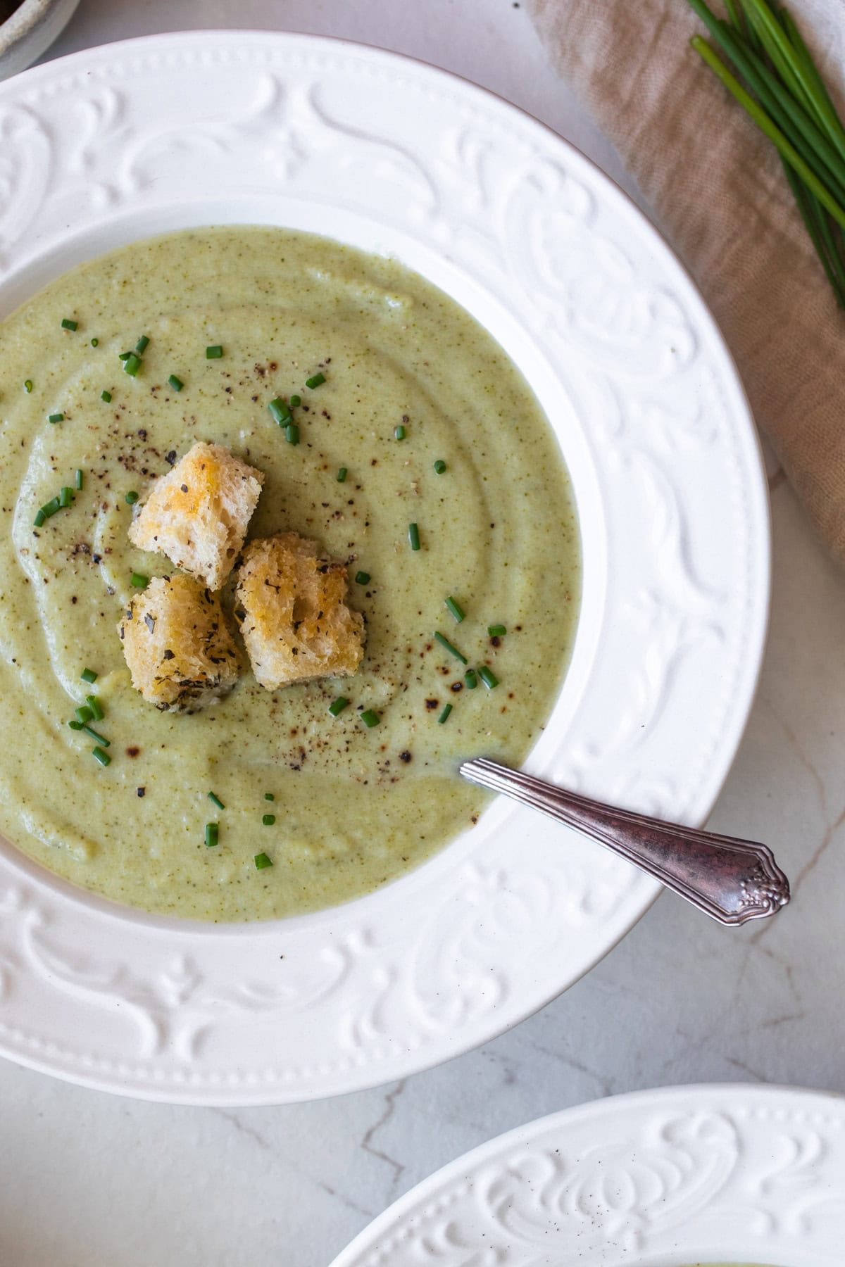 a bowl of soup with croutons on top.