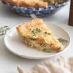 a slice of chicken pot pie served on a white circular plate.