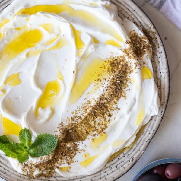 A bowl of homemade labneh drizzled with olive oil.