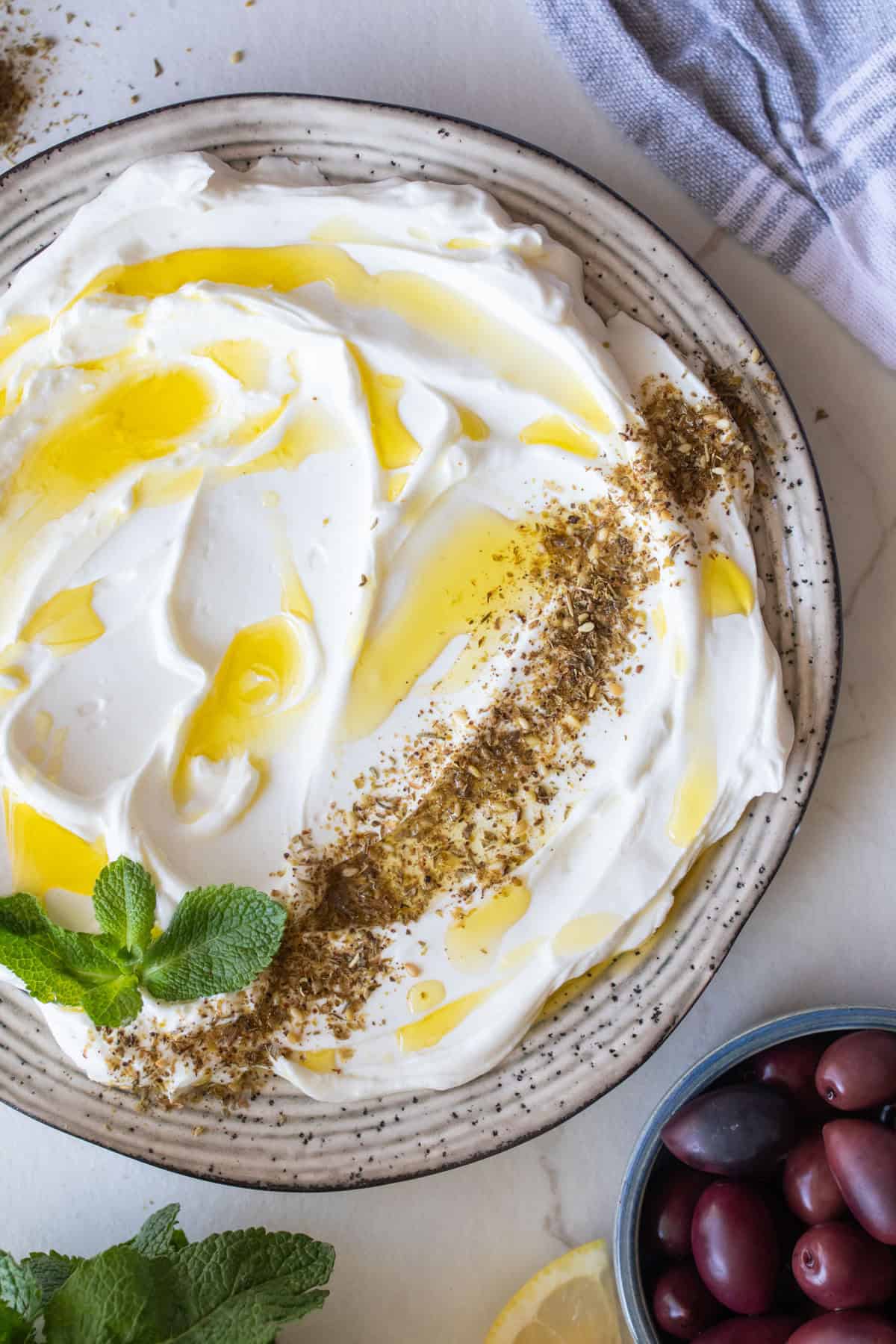 A bowl of homemade labneh drizzled with olive oil.