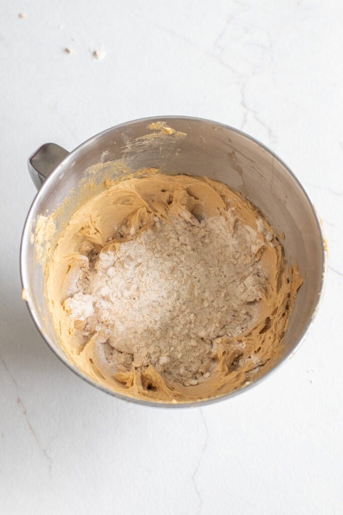 Folding in dry ingredients a little bit at a time into butter sugar mixture.