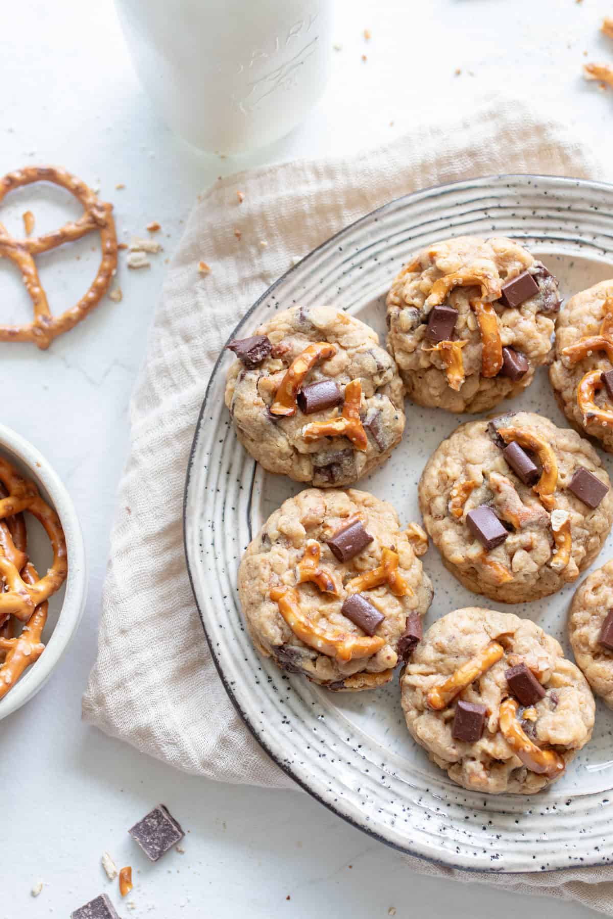 A plate of lactation cookies with chocolate chunks and pretzels.