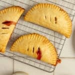 strawberry hand pies on a cooling rack.